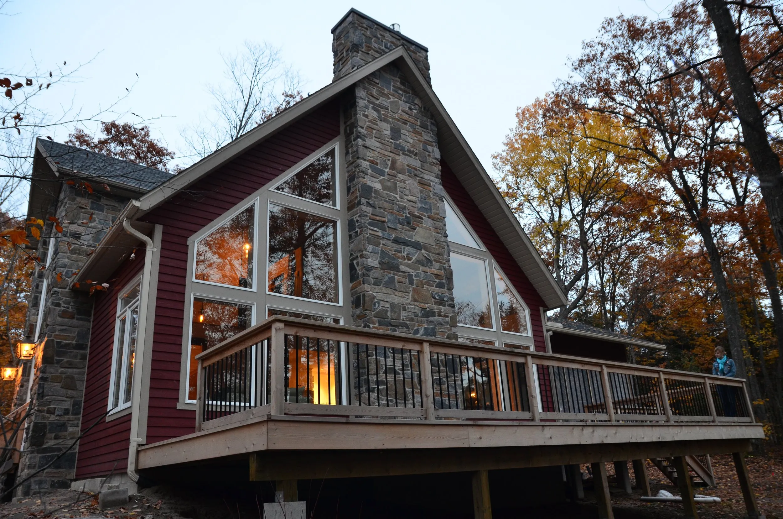 Stone and timber off-grid cottage exterior in autumn